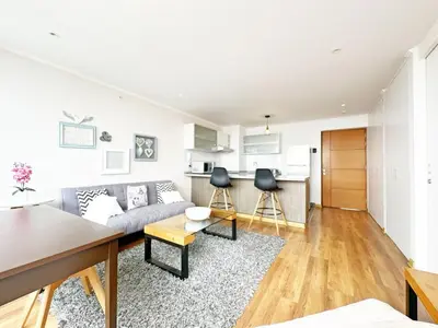 a living room with a couch and a kitchen at Moderno Dpto , Equipado, Céntrico, Vista Increible in Lima