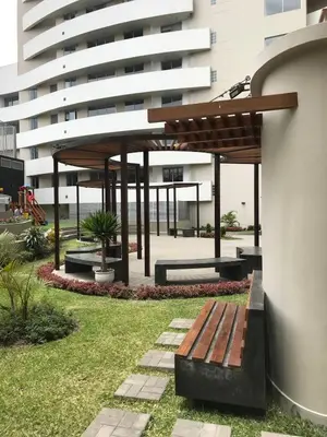 a park with a bench in front of a building at Moderno Dpto , Equipado, Céntrico, Vista Increible in Lima
