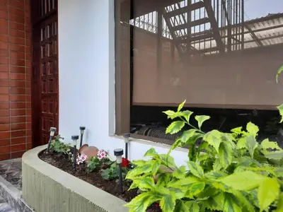 a balcony with plants and a window in a building at Minidepartamento La Molina Junin 1 in Lima