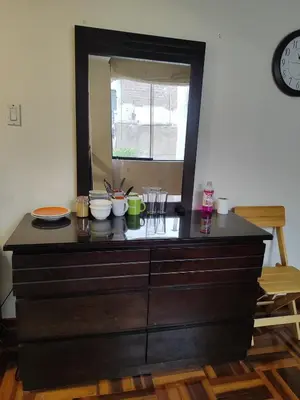 a dresser with bowls on top of it with a mirror at Amplia habitación independiente con baño privado in Lima
