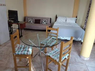 a room with a glass table and chairs and a bed at Nice stay in Los Olivos in Lima