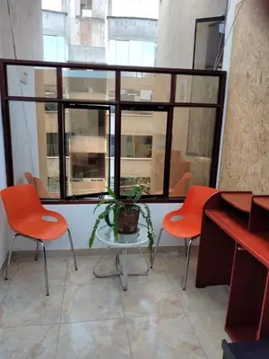 a room with two chairs and a table and a window at Comfortable stay in Los Olivos in Lima