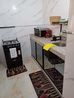 a kitchen with a counter with donuts on the floor at Family accommodation in Lima