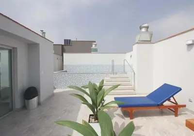 a blue chair and a plant on a balcony at Vista piloto cerca Miraflores y Centro Histórico, seguridad 24 h in Lima