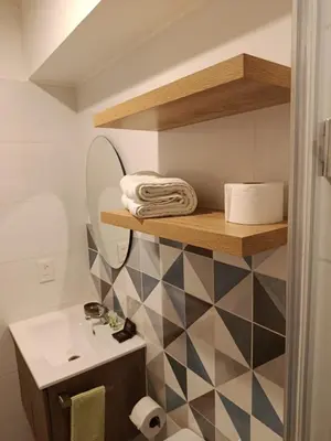a bathroom with a sink and a toilet and a shelf at LA POSADA DE GUILLE - JAVIER PRADO Este 1501 in Lima