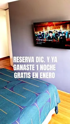 a room with a television on a wall with a carpet at El Derby 511 Apart 2 Dorm con Aire Acondicionado in Lima