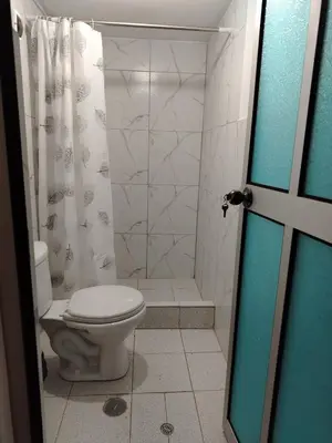 a bathroom with a toilet and a shower at Hotel House in Perú 2 in Urubamba