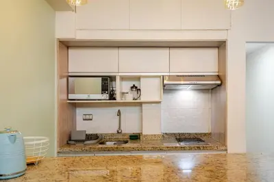 a kitchen with white cabinets and a counter top at Mini depa en el corazón de Miraflores in Lima