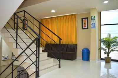 a living room with a staircase in a house at hostal kiara in Huairona