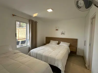 a bedroom with two beds and a window at Casa Paraquitas 