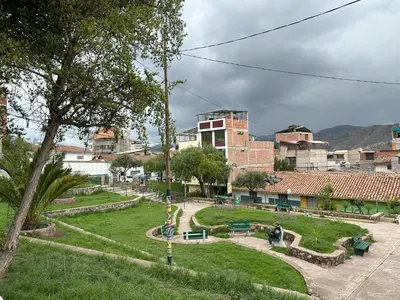 a park in a city with buildings in the background at Adela's Home in Cusco