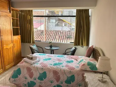 a bedroom with a bed and a window at Adela's Home in Cusco