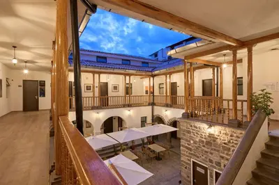 a view of therium of a building with tables and chairs at Casa Andina Standard Ayacucho in Ayacucho