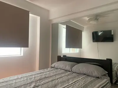 a bedroom with a bed with a large mirror at Departamento en Miraflores in Lima