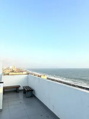a balcony with a bench and a view of the ocean at Modern and comfortable apartment nearby Aairport in Lima