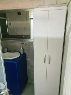 a bathroom with a sink and a mirror at Residencial Misky Dreams in Huánuco