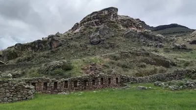 a stone building in front of a mountain at Casa Qantu Huaytará in Huaytará