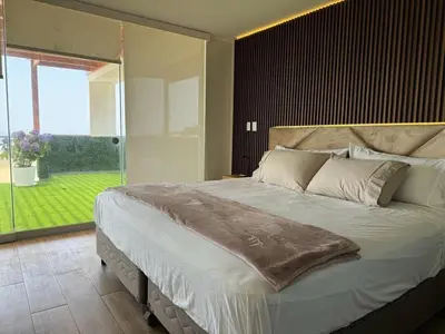 a bedroom with a large bed with a large window at Dolphin house 915 in Punta Negra
