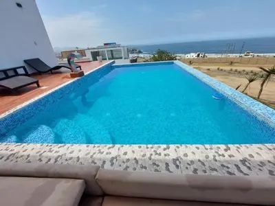 a swimming pool with a view of the ocean at Dolphin house 915 in Punta Negra