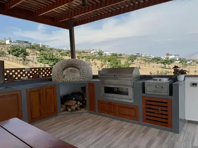 an outdoor kitchen with a stove and a grill at Dolphin house 915 in Punta Negra