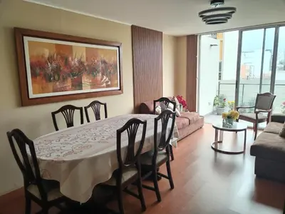 a living room with a table and chairs and a couch at Departamento en Miraflores, Lima 3HAB in Lima