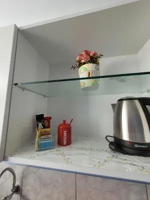 a glass shelf in a kitchen with a pot on it at AlojamientoMarín in Lima