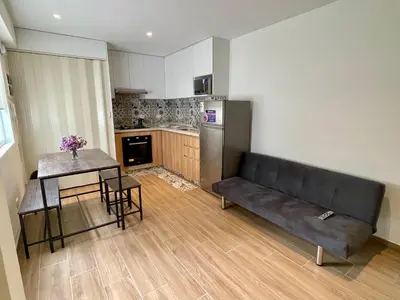 a living room with a couch and a table at Departamento in Magdalena del Mar in Lima