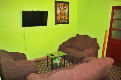 a living room with two couches and a flat screen tv at Casita San Pedro in Cusco