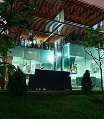 a large glass building with a table in front of it at casa en playa de condominio mikonos in Asia