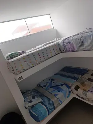 two bunk beds in a room with a window at casa en playa de condominio mikonos in Asia