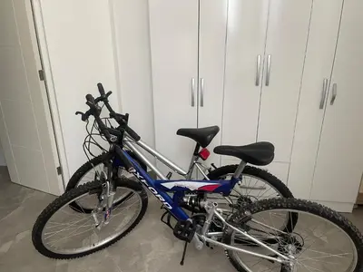 a bike parked in a room with white cabinets at Hermosa casa de playa Asia in Lima