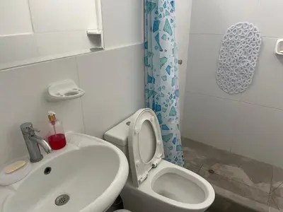 a small bathroom with a toilet and a sink at Hermosa casa de playa Asia in Lima