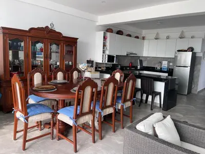 a kitchen with a dining room table and chairs at Hermosa casa de playa Asia in Lima