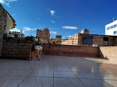 a brick wall with a table on a roof at Apart Hotel Valdelomar in Ayacucho