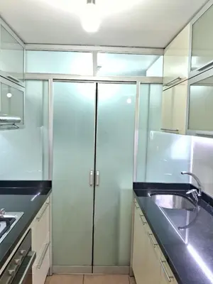 a kitchen with a sink and a glass refrigerator at CasaBlanca2 in Lima