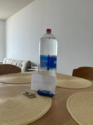 a bottle of water sitting on top of a table at Departamento en San Bartolo in San Bartolo