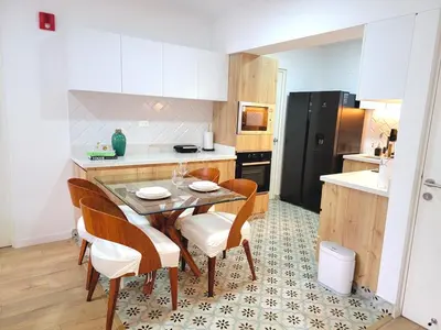 a kitchen with a table and chairs and a black refrigerator at Bello y amplio apartamento, en la mejor zona de Barranco in Lima