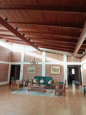 a large living room with couches and chairs at Country house in Pachacamac in Lima