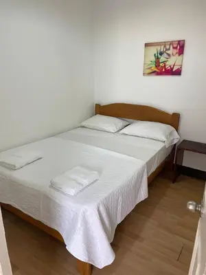 a bedroom with a bed with two white pillows at Lindo departamento muy cerca a la playa in Punta Negra