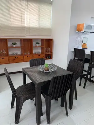 a black table and chairs in a room with a kitchen at Mini Dpto frente al mar playa Pta N in Punta Negra
