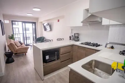 a kitchen with a sink and a stove top oven at Barranco Moderno Style 1BR in Lima