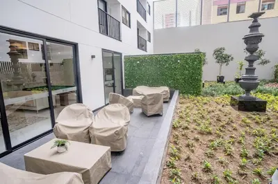 a patio with chairs and tables in a building at Barranco Moderno Style 1BR in Lima