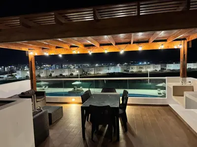 a living room with a table and a view of a pool at Casa de Playa - Asia - SELENE beach house in Asia