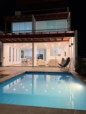 a swimming pool in front of a house at Casa de Playa - Asia - SELENE beach house in Asia