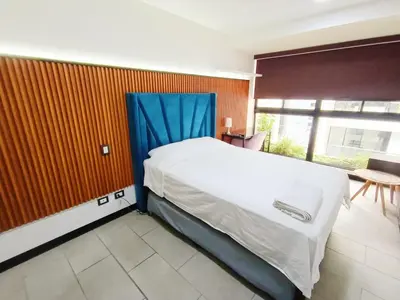 a bedroom with a large bed with a blue canopy at Apartment in San Isidro in Lima