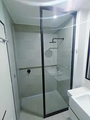 a shower with a glass door in a bathroom at Apartment in San Isidro in Lima