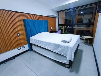 a bedroom with a bed with a blue cover on it at Apartment in San Isidro in Lima