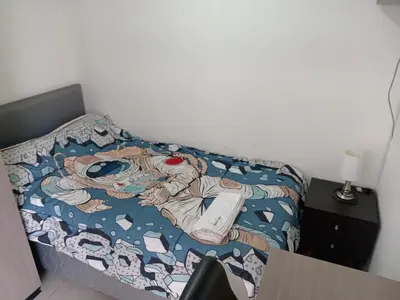 a bedroom with a bed with a video game on it at 2BR Deluxe Apartment in San Isidro in Lima