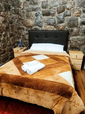 a bedroom with a bed with two towels on it at Departamento 2 Waynapata Centro Historico Cusco in Cusco