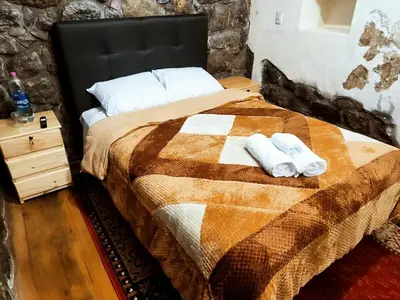 a bedroom with a bed with two towels on it at Departamento 2 Waynapata Centro Historico Cusco in Cusco